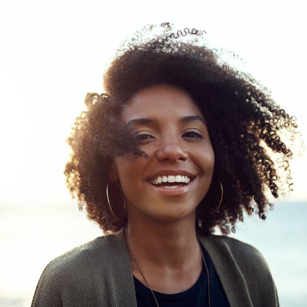 Shot of an attractive young woman enjoying a vacation along the coast
