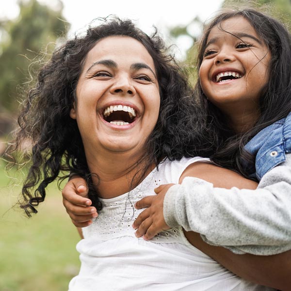 Happy mother having fun with her daughter outdoor