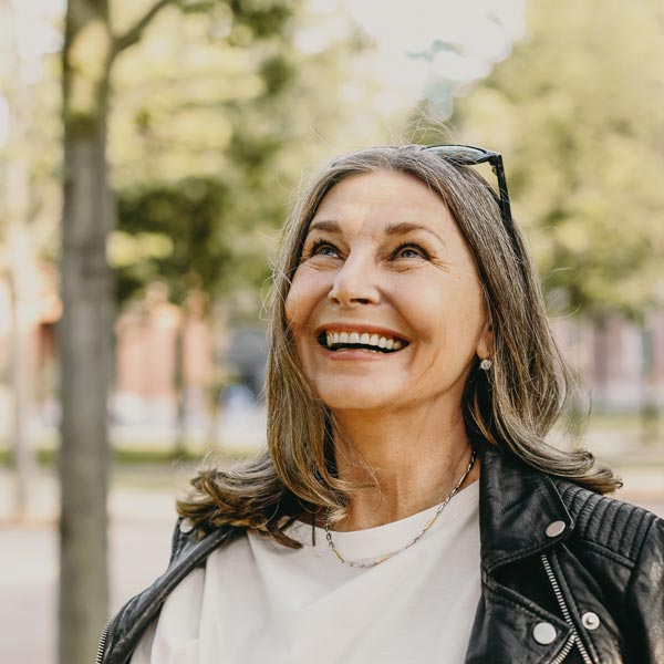 Cheerful overjoyed middle aged woman wearing sunglasses on her head