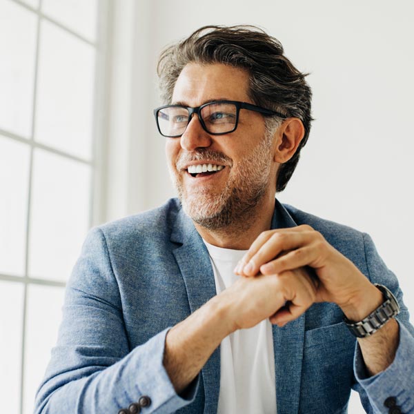 Business man looking outside the window in an office