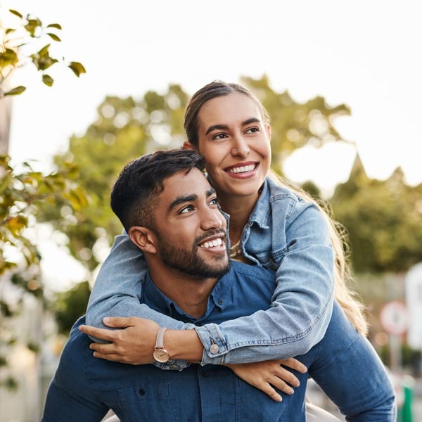 Young man and woman having fun, walking and bonding in the town street