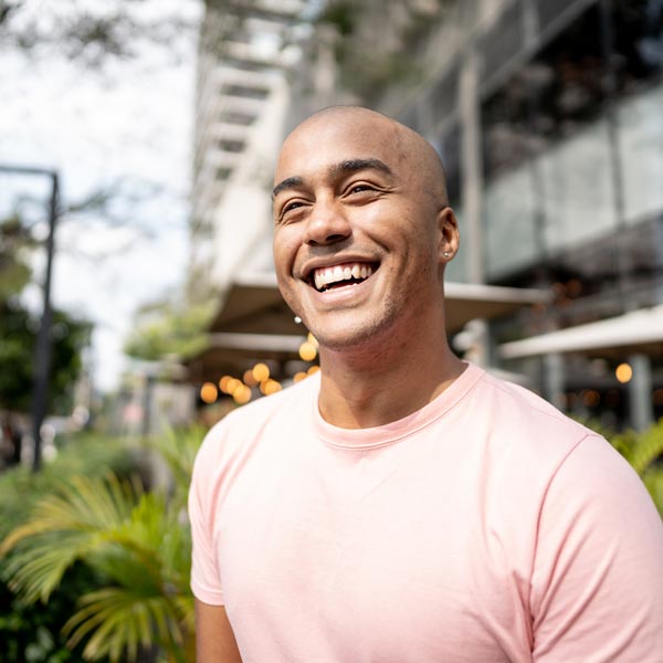 Happy young man looking away and laughing