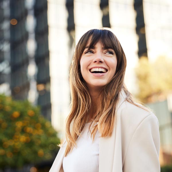 Young Professional Walks, Looking Back with a Broad Smile.