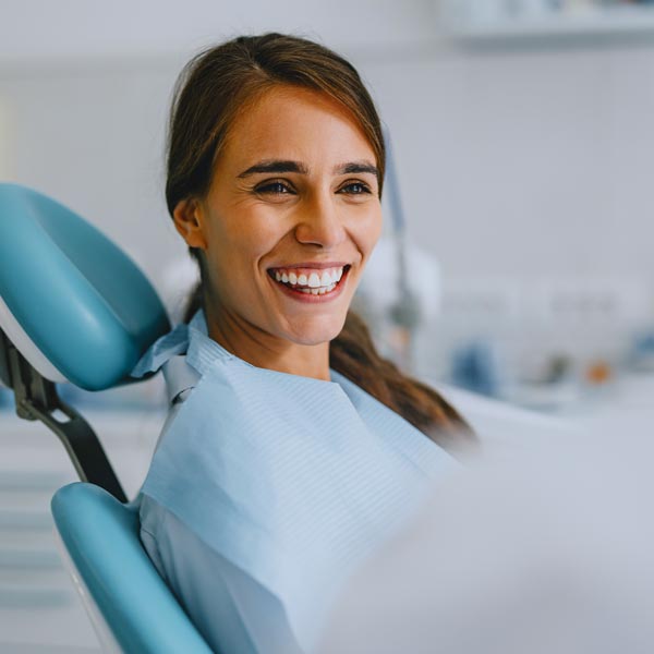 Happy Woman Smiling at the Dentist Office